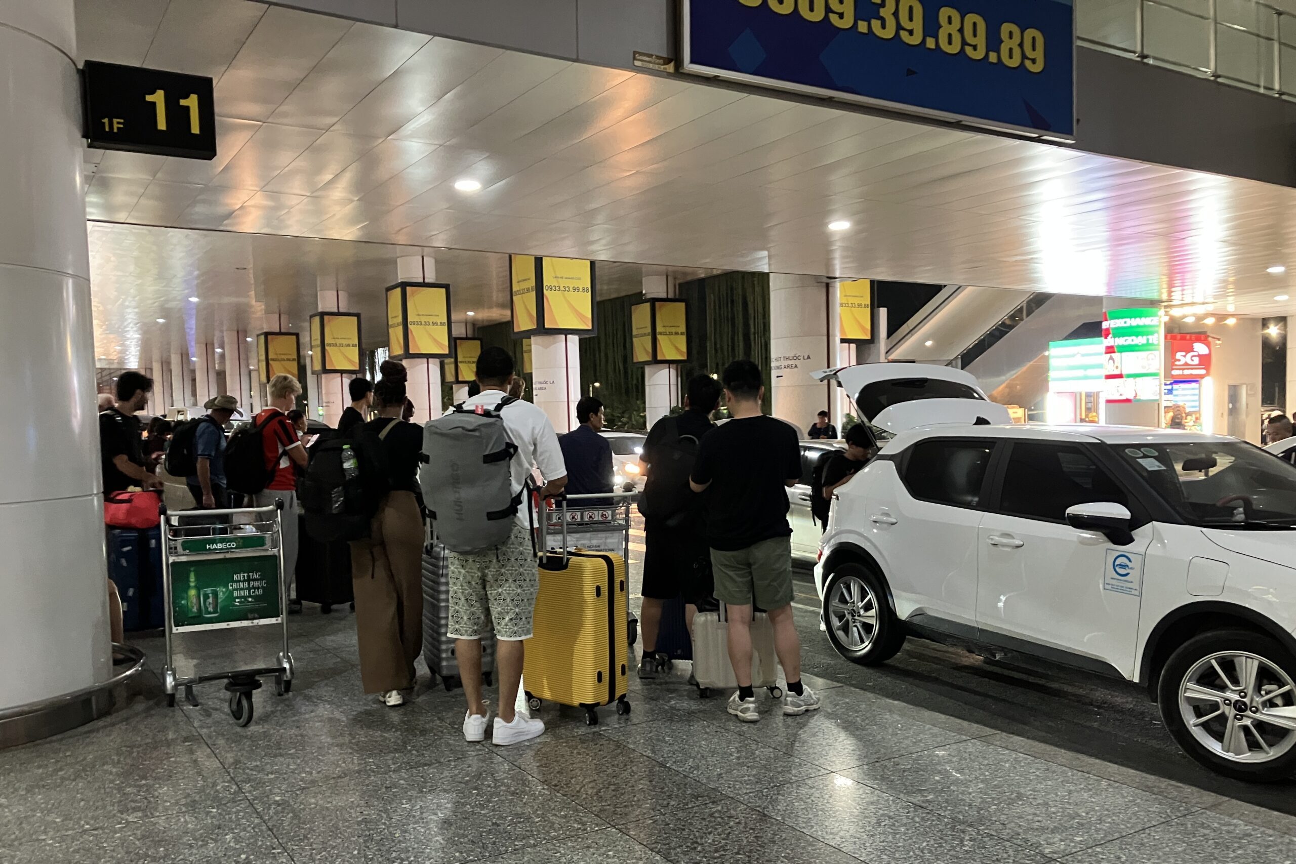 ノイバイ空港T2到着階のGrab乗車エリア付近で待つ旅行者